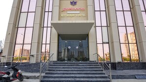 A building with a sign reading "Ganeshwaram Restaurant & Hotel" and a set of stairs leading to the entrance. - Oriva Ganeshwaram 149 (Noida)