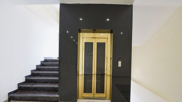 A staircase leading to a door with a digital display showing the number 2. - Oriva Ganeshwaram 149 (Noida)