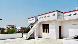 A modern building with a staircase leading to a flat roof area. - Fabhotel Noida Dreamz (Noida)