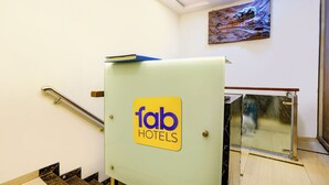 A hotel elevator with a sign reading "fab hotels" and a painting above it. - Fabhotel Amfahh Inn (Mumbai)