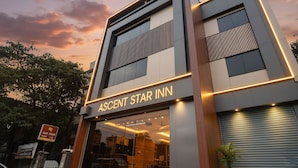 A modern hotel named "Ascendant Star Inn" with a prominent entrance and a visible air conditioning unit outside. - FabExpress Ascent Star Inn (Mumbai)