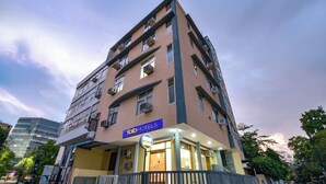 A multi-story hotel with a prominent 'fabHOTELS' sign, outdoor seating area, and a gated entrance. - Fabhotel Silver Stay 04 (Jaipur)