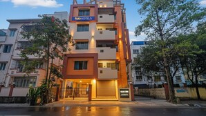 A multi-story building with a 'fabHOTELS' sign, featuring a modern architectural design with balconies and a gated entrance. - Fabhotel Casa Inn (Barasat)