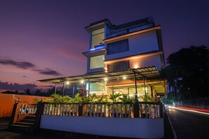 A modern hotel with a two-story structure, a covered outdoor area with plants, and a visible sign for 'Fab Hotels'. - Fabhotel Balaji Resort (Calangute)