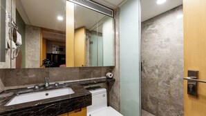 A bathroom with a marble sink, a toilet, and a shower area. - Guangzhou Duoya Intl. Service Apartment (Guangzhou)