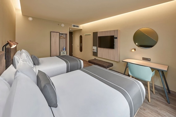 Recharge in crisp linens with a dedicated desk workspace.