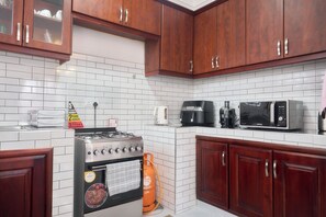 Economy Apartment, City View | Private kitchen | Fridge, microwave, oven, cookware/dishes/utensils - B&S Luxe Living (Kampala)