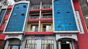 A hotel with a reception area, a restaurant, and multiple balconies. - Hotel Anshdeep Palace (Jogindarnagar)