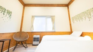 A bedroom with a bed, a chair, an air conditioner, and a window with curtains. - Yasunaya (Toyako)