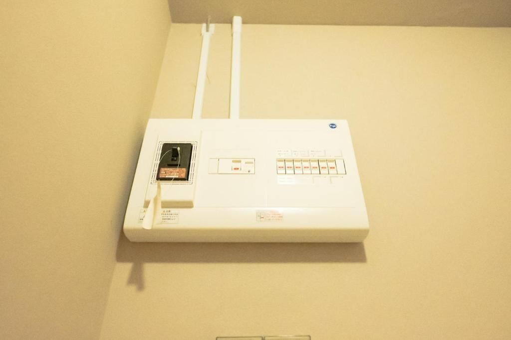 A white electrical panel with a control panel and a power cord.