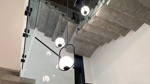 A modern staircase with glass railings and a ceiling light fixture. - Brand new 3-bedroom Villa & 1-bed bungalow  Las Terrenas with AC, WiFi (Las Terrenas)