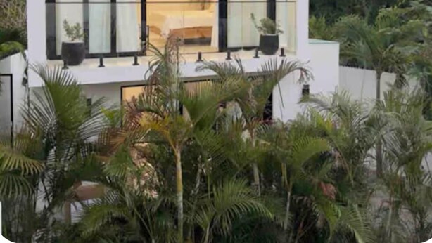 A modern, white building with large windows, a ceiling fan, and potted plants. - Brand new 3-bedroom Villa & 1-bed bungalow  Las Terrenas with AC, WiFi (Las Terrenas)