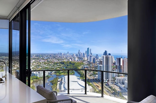 A balcony with a city view, a sofa, and a sink.