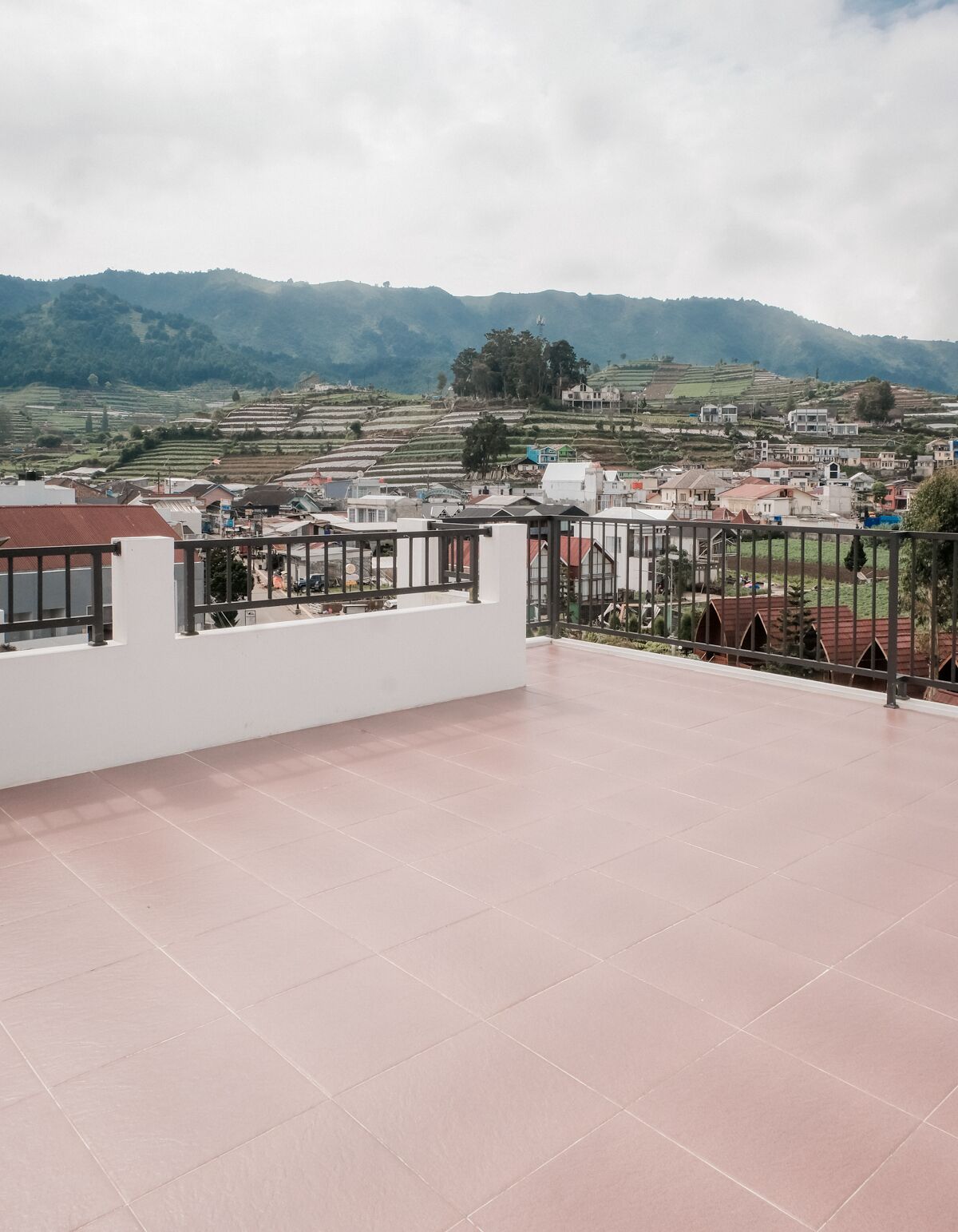 A terrace with a view of terraced fields and buildings.