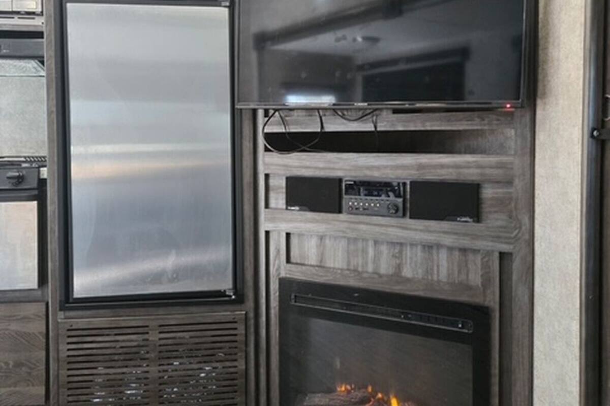 A kitchen with a built-in refrigerator, microwave, and oven.