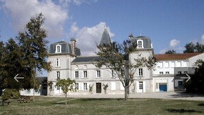 A large, historic building with a symmetrical facade, multiple windows, and a prominent central tower. - LES LOGIS DU CHATEAU MARIE VICTORIA on the way to ST-JACQUES-DE-COMPOSTELLE (La Vergne (17400))