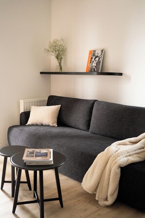 Apartment, 2 Bedrooms, Balcony | Living area | 55-inch Smart TV with cable channels