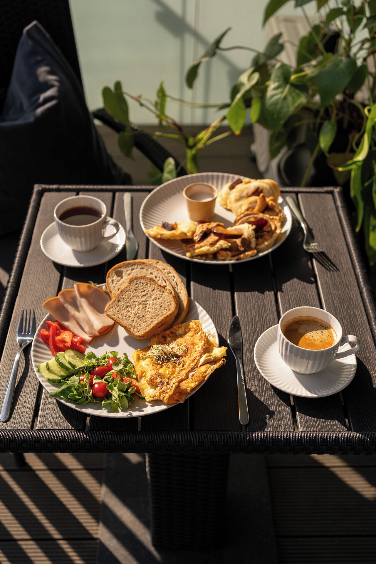 A table set with breakfast including toast, eggs, vegetables, and coffee.