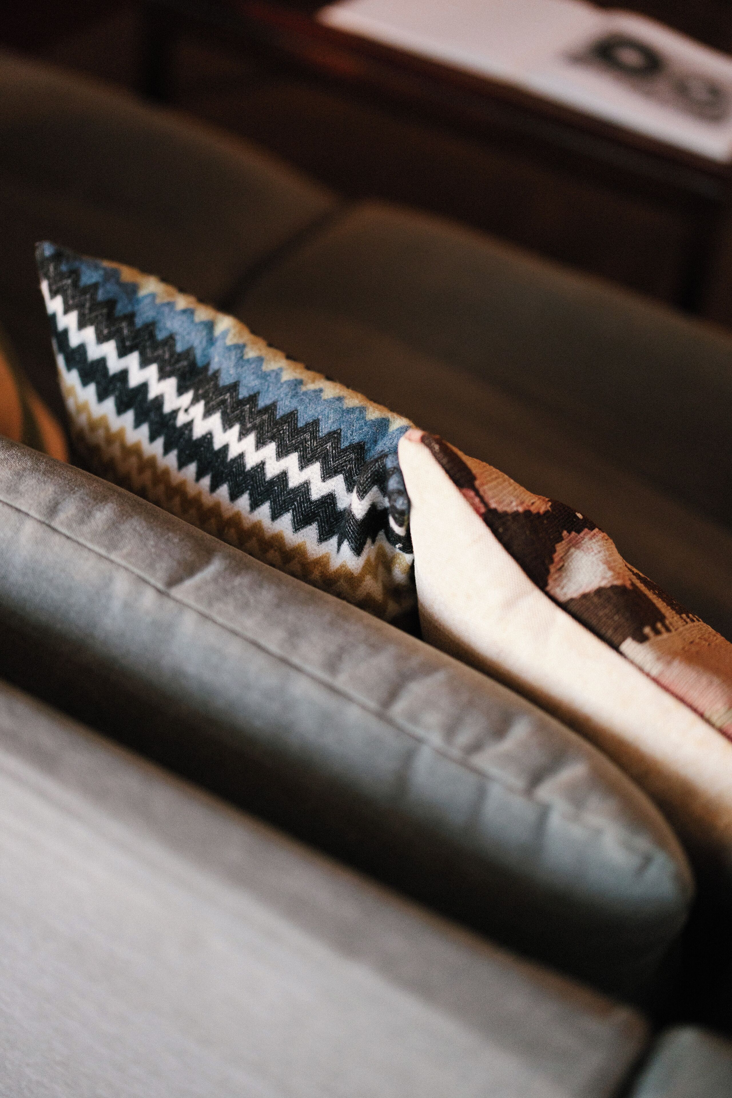 A close-up of a patterned pillow on a couch.