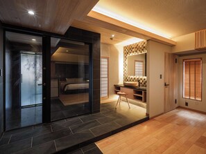 A modern interior with a bedroom, bathroom, and a small sitting area. - Hakonehibarino (Hakone)