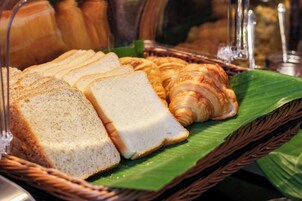 A display of bread and pastries in a bakery setting.