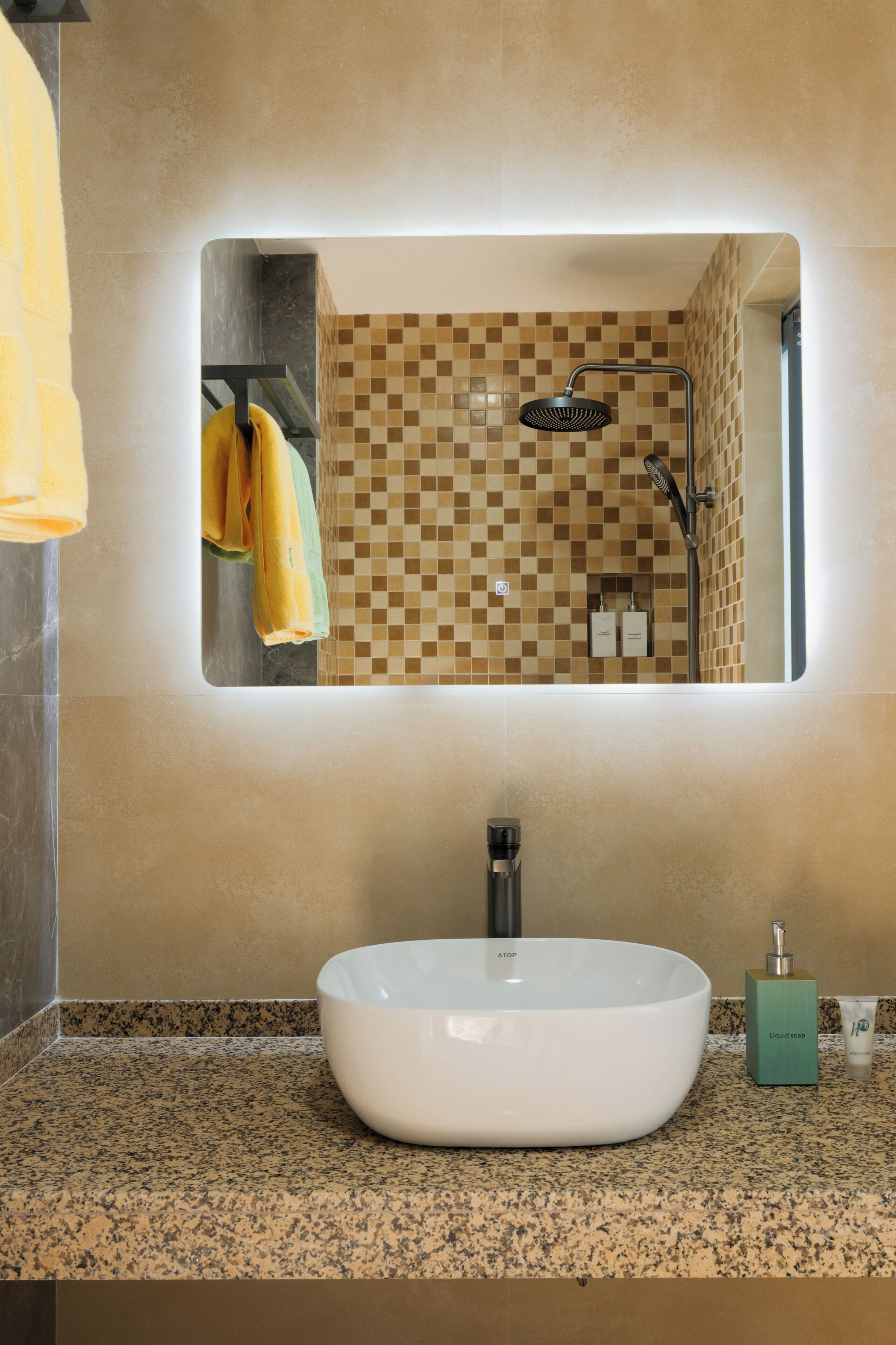 A bathroom with a white sink, a mirror, and a checkered tile backsplash.