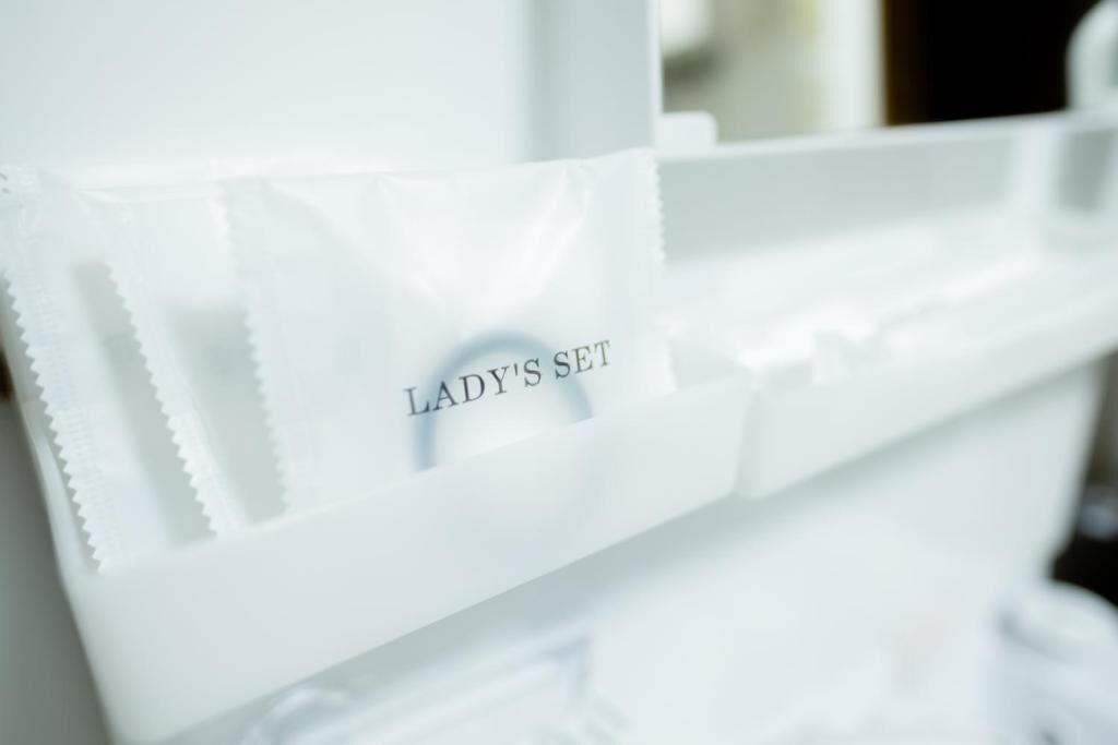 A white storage unit with a label reading "LADY'S SET".