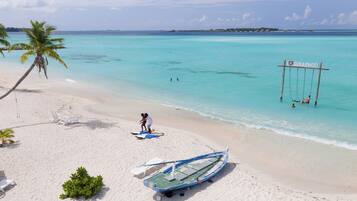 On the beach, white sand, free beach cabanas, sun-loungers