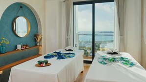 A hotel room with two beds, a large window with a view, a mirror, and a shelf with decorative items. - h78 Guraidhoo (Guraidhoo)