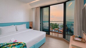 A hotel room with a large bed, a balcony with a view of the sea, and a small table with a tray. - h78 Guraidhoo (Guraidhoo)