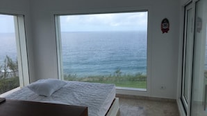 A bedroom with a large window offering a view of the sea. - Villa with Ocean View in Cap Zebib, Ras Jebel (Ras Jebel)