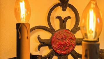 A wall-mounted candle holder with two lit candles.