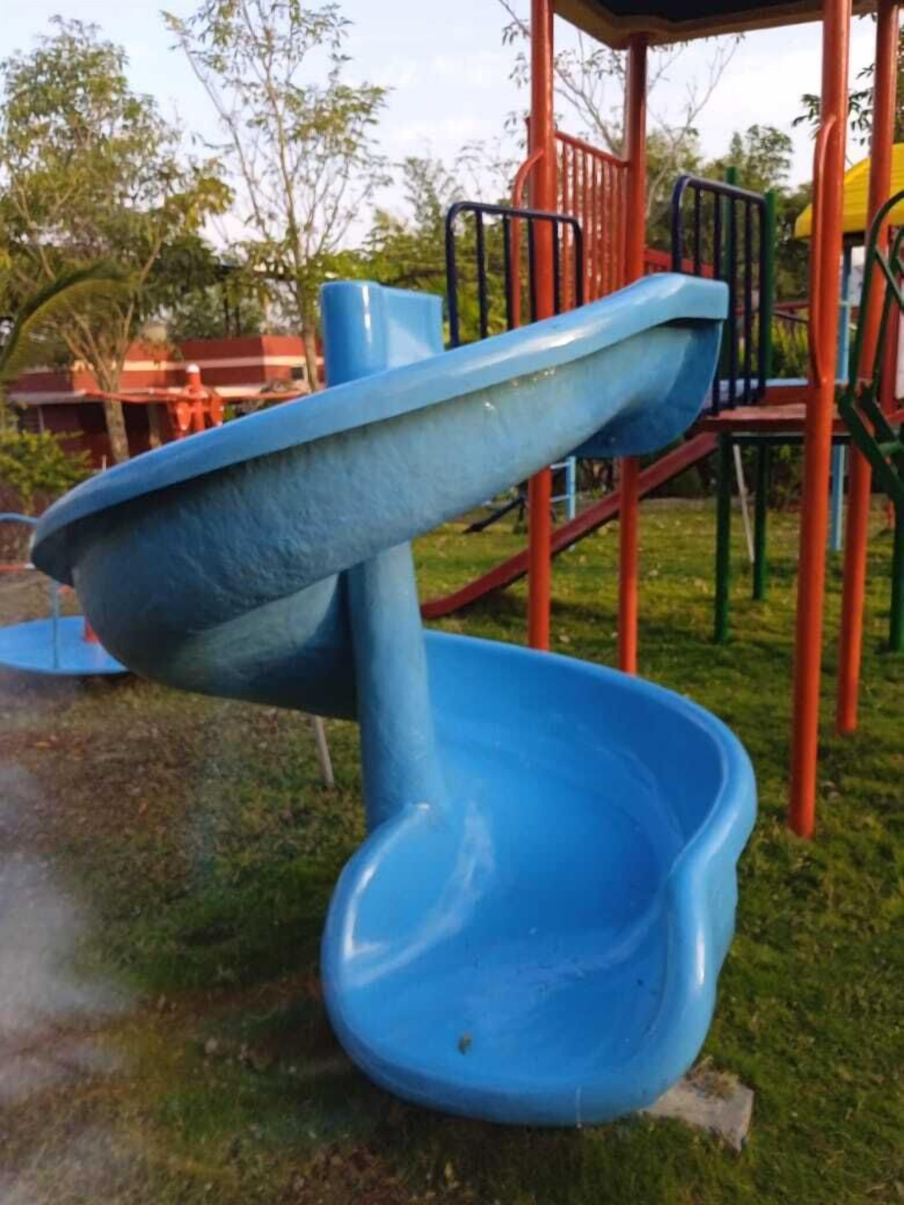 Ein Spielplatz mit einer blauen Rutsche und Klettergerüsten.