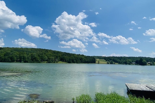 Savor stunning lake views from the porch, luxurious hot tub, cozy firepit, or manicured lawn. Enjoy the ideal backdrop for relaxation and unforgettable moments.