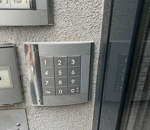 A keypad entry system with numbers 0-9 and symbols for access control.