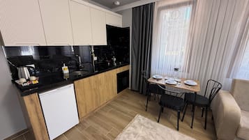 Deluxe Apartment, Balcony, Partial Sea View | Private kitchen | Mini-fridge, oven, stovetop, high chair