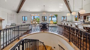 A spacious interior with a curved balcony, a dining area, and a kitchen.