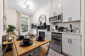 Microwave, stovetop, coffee/tea maker, dining tables