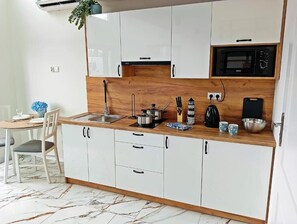 Mini-fridge, microwave, stovetop, cookware/dishes/utensils