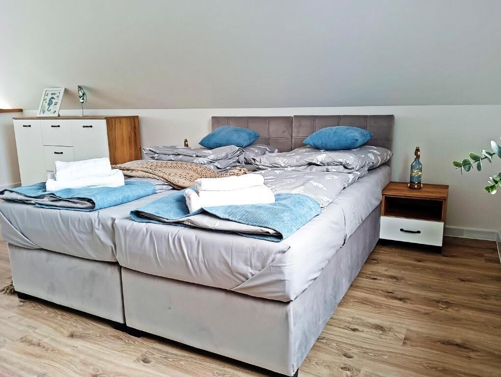 A bedroom with a bed, bedside tables, a nightstand, and a dresser.