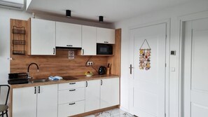 Mini-fridge, microwave, stovetop, cookware/dishes/utensils