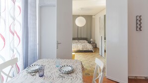 A hotel room with a dining area, a bed, and a bathroom. - A Casa di Silvia by Wonderful Italy (Catania)