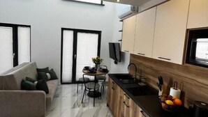 A modern apartment with a kitchen, dining area, and living room. - ZATOR Domki INTERSTYL (Zator)