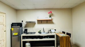 Fridge, microwave, coffee/tea maker, cookware/dishes/utensils