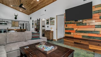 Signature House, 2 Bedrooms, Non Smoking, Pets allowed | Living room | 49-inch Smart TV with digital channels, books