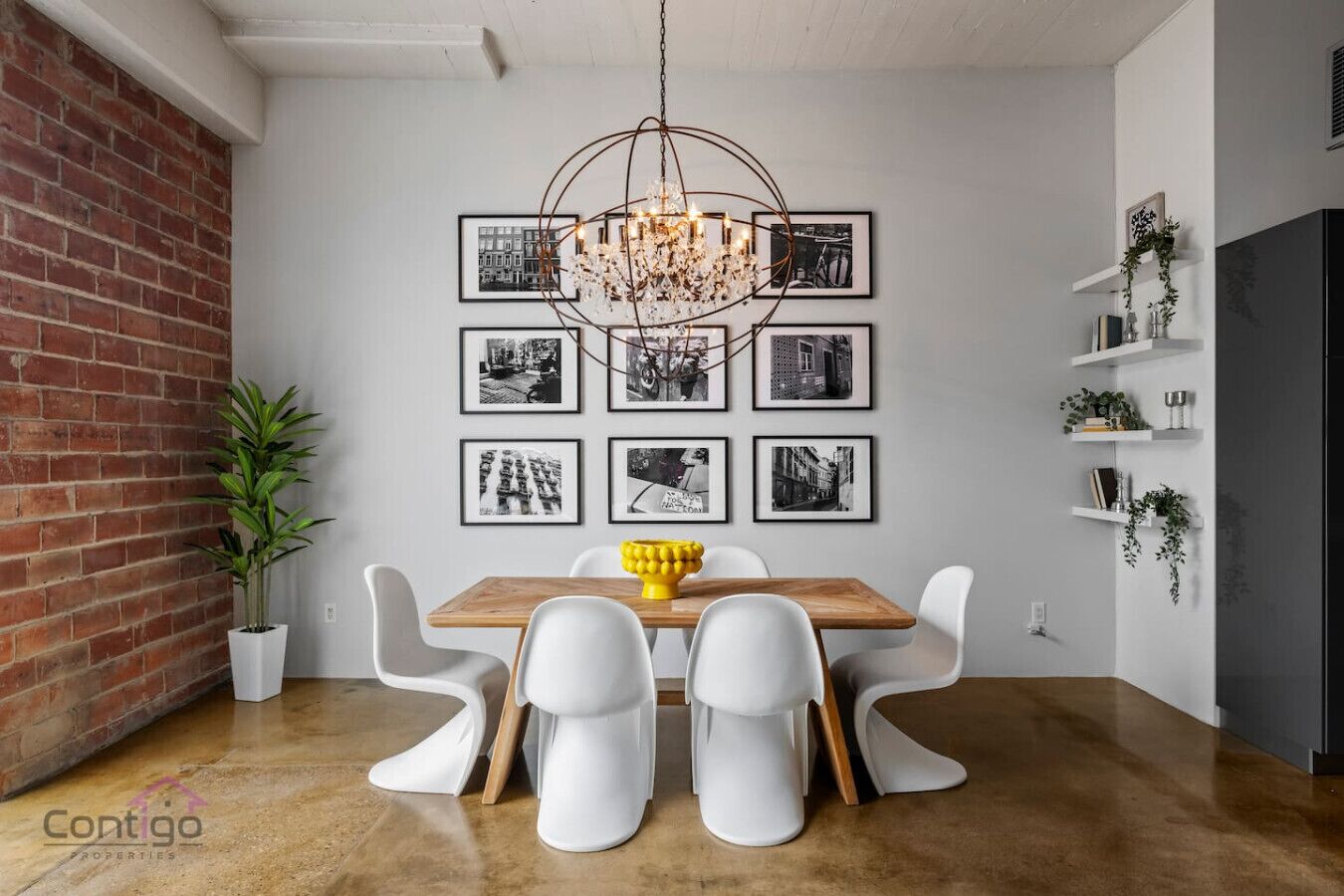 Stylish dining area with seating for six, modern chandelier, and curated wall art. Perfect for sharing meals in the heart of downtown Edmonton.