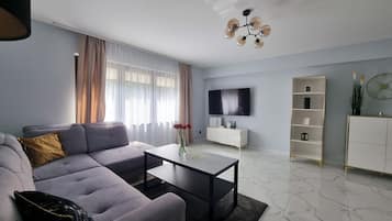 Deluxe Apartment, Balcony | Living area | 42-inch Smart TV with digital channels