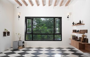A room with a large window, a checkered floor, and a wooden ceiling.