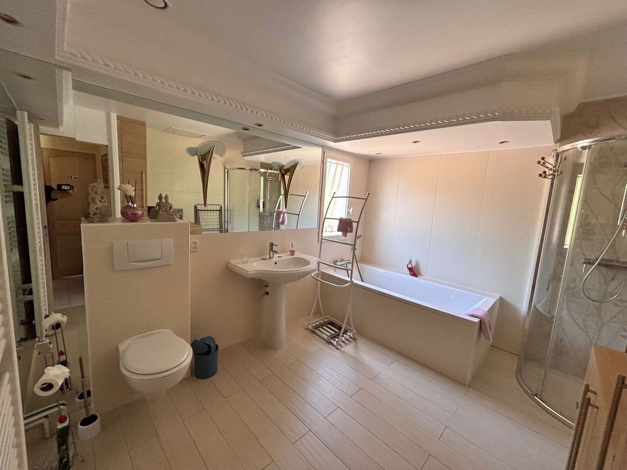A bathroom with a toilet, sink, shower, and a bathtub.