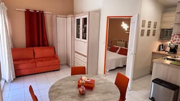Habitación cuádruple Deluxe, vistas a la piscina | Zona de estar